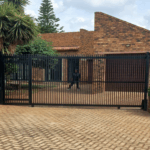 Custom automated sliding gate with internal swing pedestrian gate
