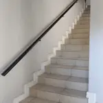 Side wall railing for stairs in a home